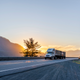 truck on a road at sunset